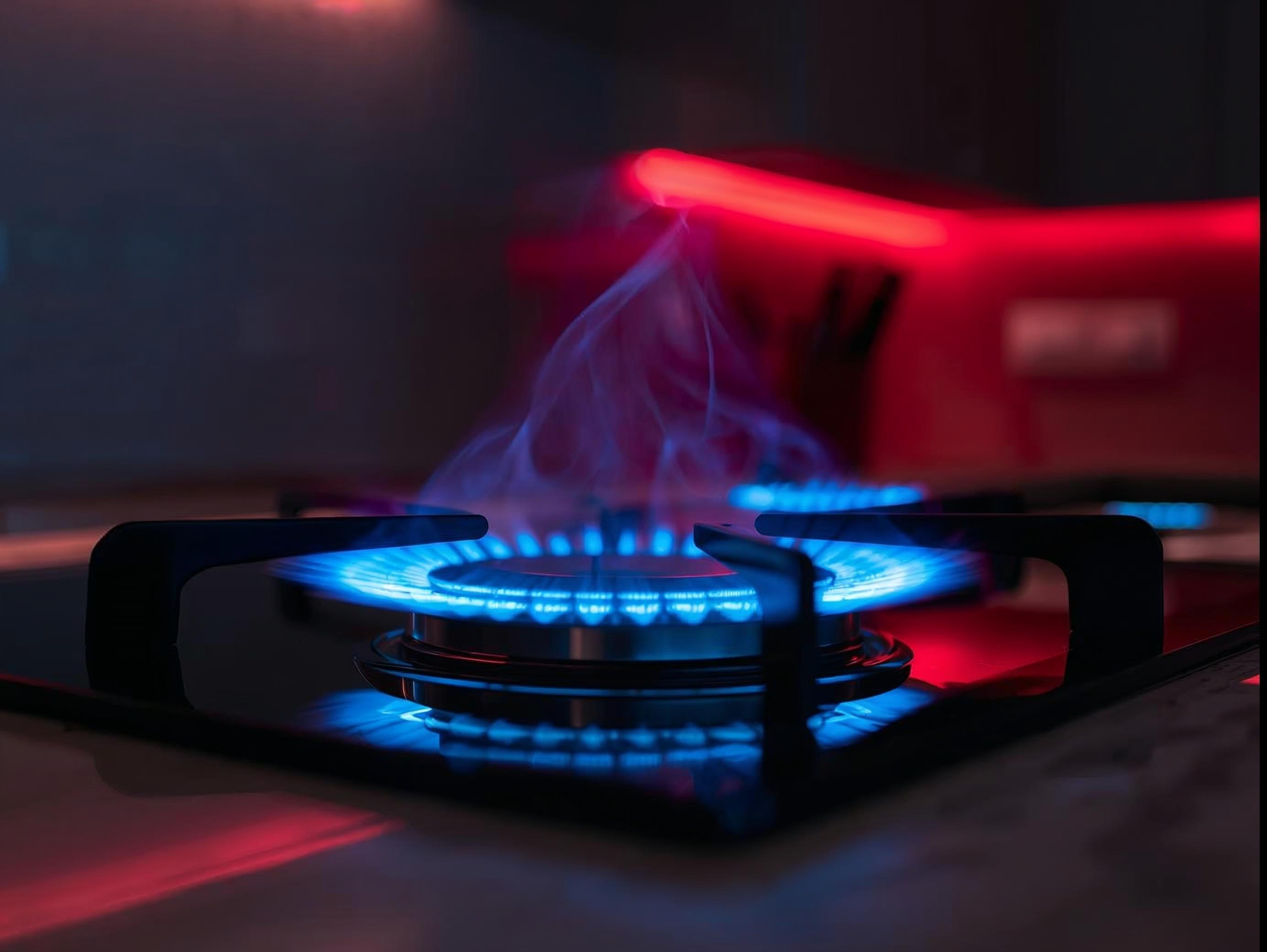 Close-up pan on gas hob with vivid blue flame, modern kitchen, subtle red_deep blue accents, no text, wide banner.